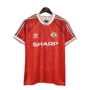 Tienda Hincha Futbolero, Manchester United 1990/92, Camiseta United Retro, Manchester United primera equipación, Camisetas fútbol clásicas, Ropa retro Manchester United, Camiseta fútbol vintage, Colección Red Devils, Historia Manchester United, Camisetas de colección, Estilo retro fútbol, Old Trafford legend.
