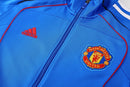 Chándal hombre Manchester United temporada 2025 2026 conjunto sudadera azul y pantalón largo negro calidad 1.1 premium oficial.
