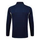 Sudadera hombre Real Madrid temporada 2025 2026 color azul marino con detalles verdes oficial fútbol merengue técnica transpirable entrenamiento urbana navy green.
